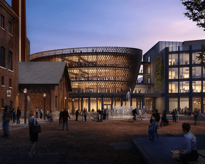 Dusk rendering of building with people walking around The Distillery District