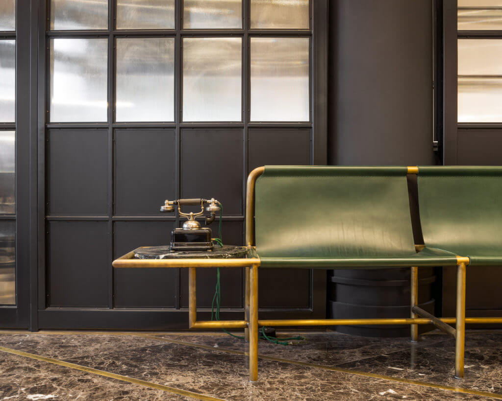 Photo of vintage chair with rotary phone on a side table in the lobby of The Broadview Hotel