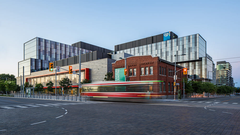 Photo of streetcar passing YMCA building Canary District