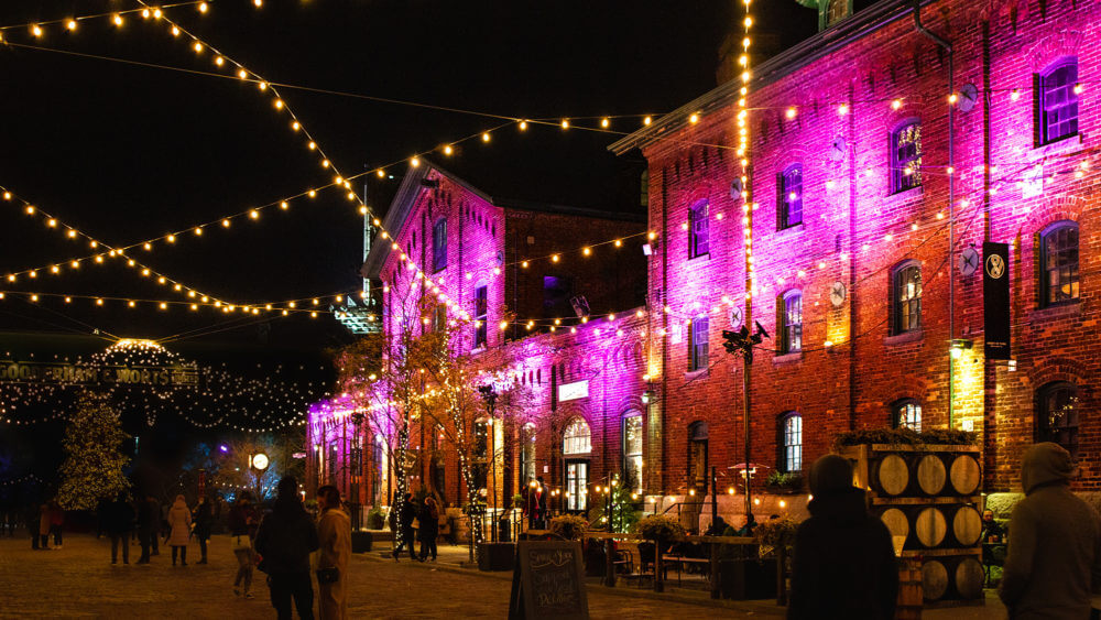 Night time photo of string lights and decorations up during the Christmas Market at the Distillery District