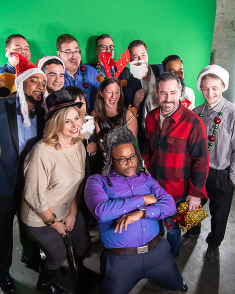 Dream Employees at the Christmas party dressed up posing for a photo.