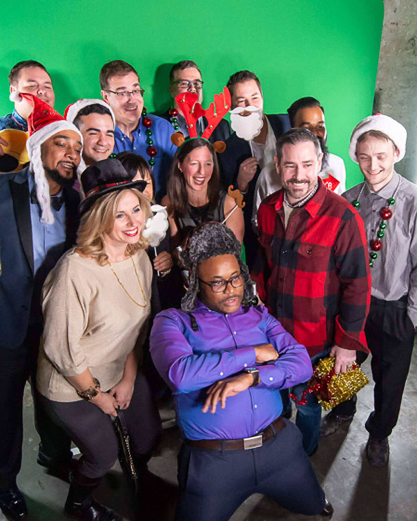 Dream Employees at the Christmas party dressed up posing for a photo.