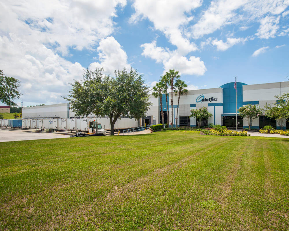 exterior image of Dream Industrial Warehouse Building in Orlando Florida with green grass and palm trees