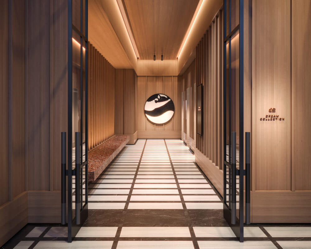 Rendering of lobby of building two doors open to a marble floor and warm wood walls with two elevators to the right.