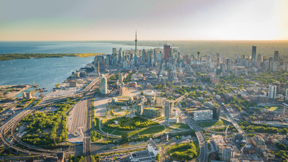 Aerial rendering of Toronto's Downtown East including Canary District, Distillery District, West Don Lands and the CN Tower in the background.