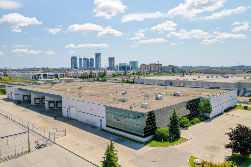Aerial image of Dream Industrial Warehouse Building in Vaughn, Ontario with city skyline in the background.