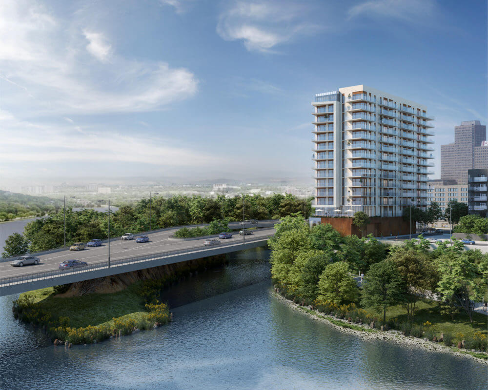 Aerial Rendering of Zibi Community with views of the water and bridge with cars, surrounded by greenery.