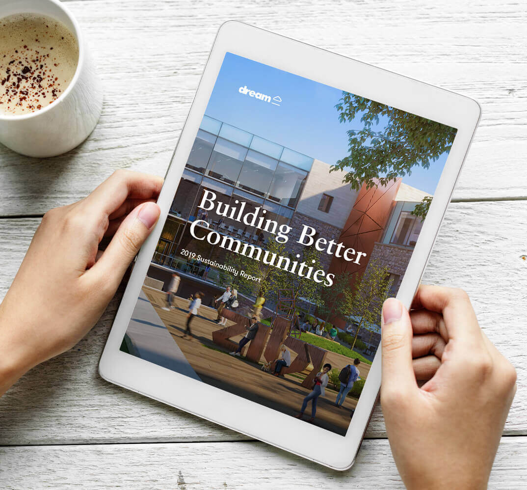 Image of Dream's 2019 Sustainability report on an I pad being held by two hands