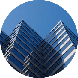 Dream Office REIT, a tall glass building reflects the bright blue clear sky
