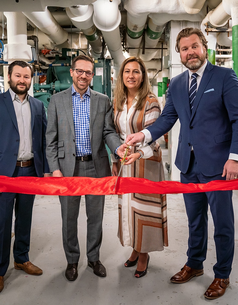 Gordon Wadley. COO Dream Office REIT, Ana Bailao, Head of affordable housing and public affairs, Lee Hodgkinson, Head of Sustainability and Technical Service at a Ribbon cutting in a industrial warehouse at for Dream's Net Zero Commitment